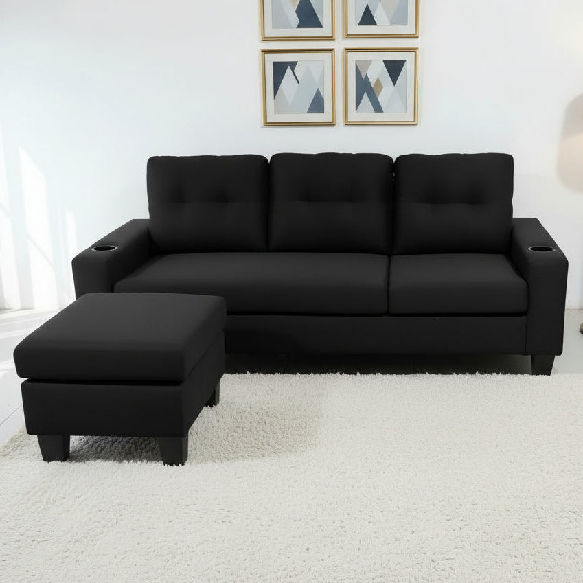 Black sectional sofa in a living room setting with a coffee table and decor.