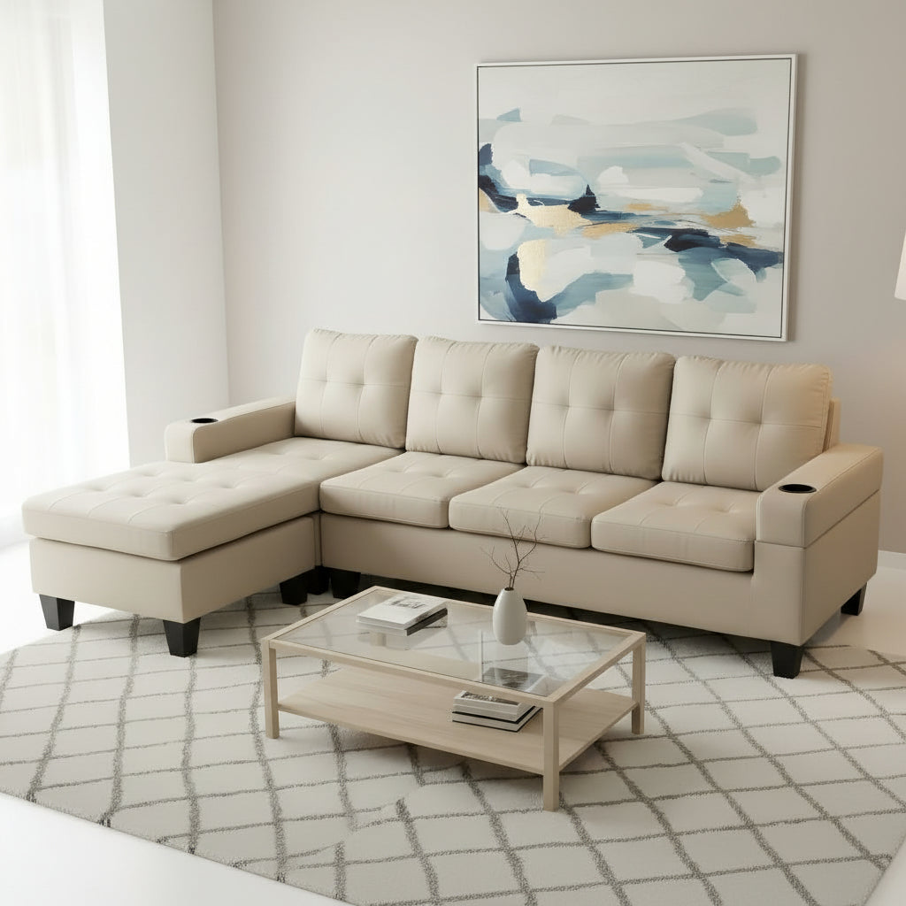 Beige sectional sofa in a living room setting with a coffee table and abstract art on the wall.
