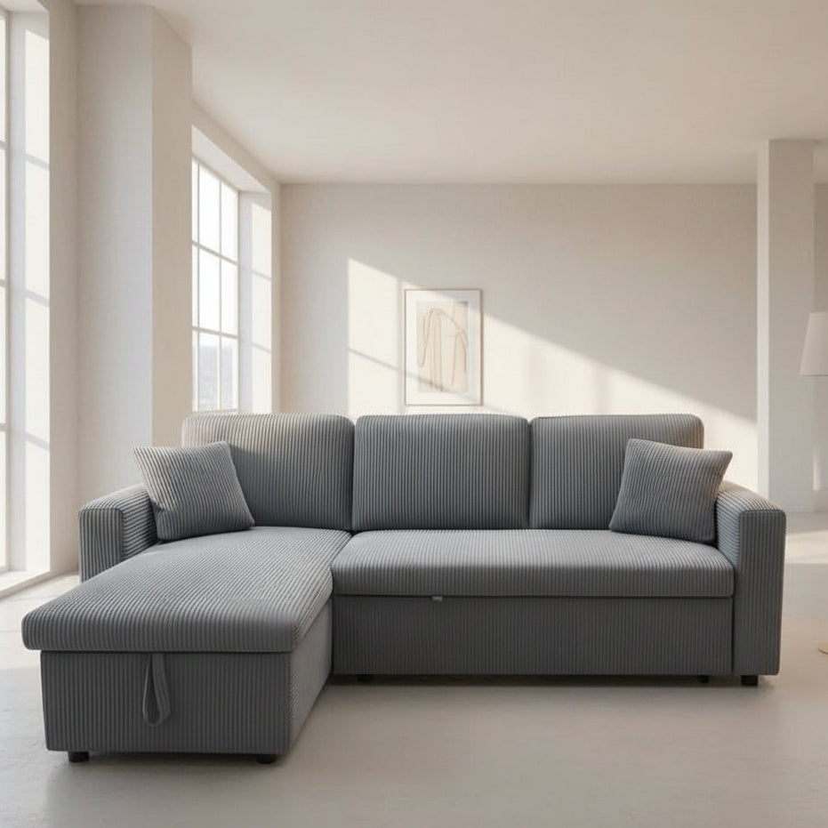 Gray sectional sofa in a modern living room with light-colored walls and floor.