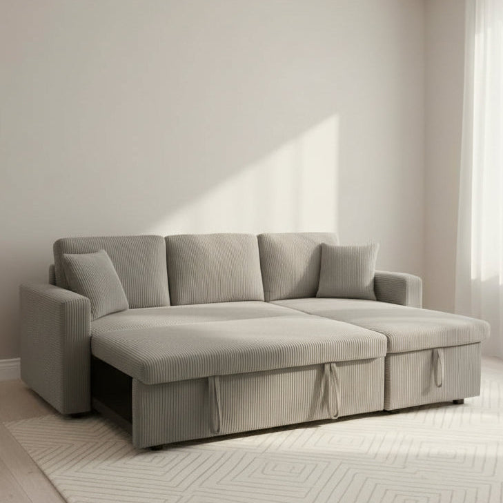 Light gray bed corduroy sofa in a minimalistic room with neutral walls and flooring.