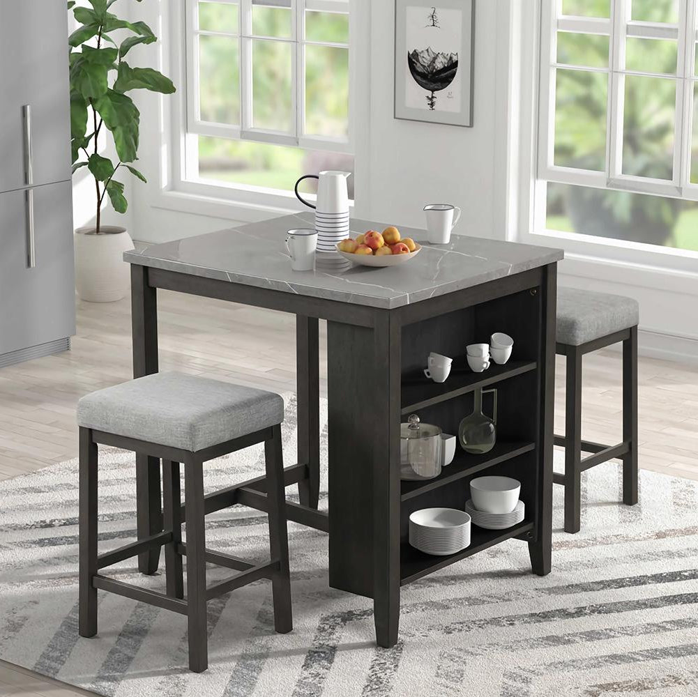 A gray faux marble counter table with built-in storage and two black stools with foam cushions in a kitchen setting.