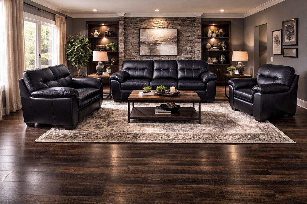 Modern living room with black leather sofa set and decorative elements.
