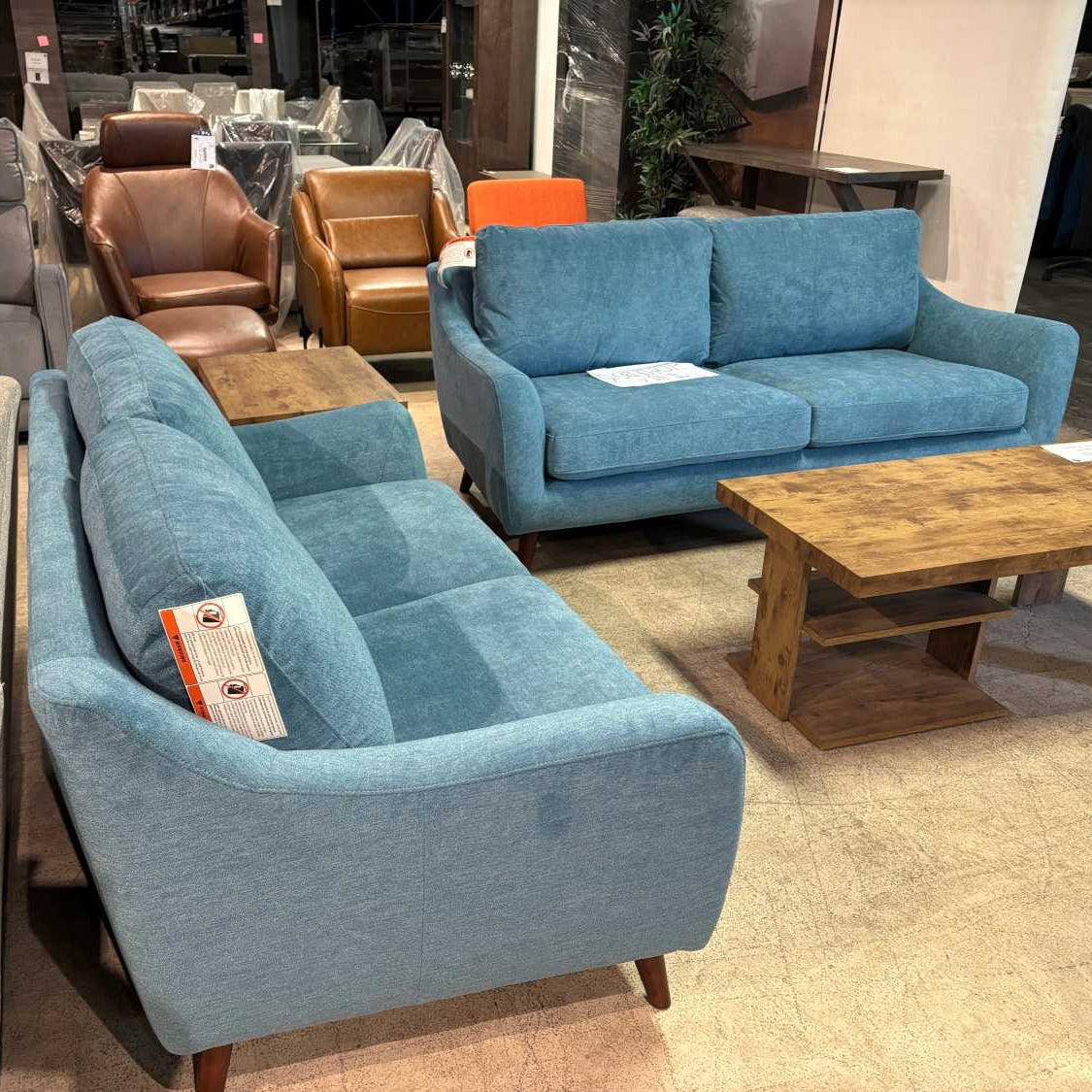 Blue sofa in a showroom with other furniture options.
