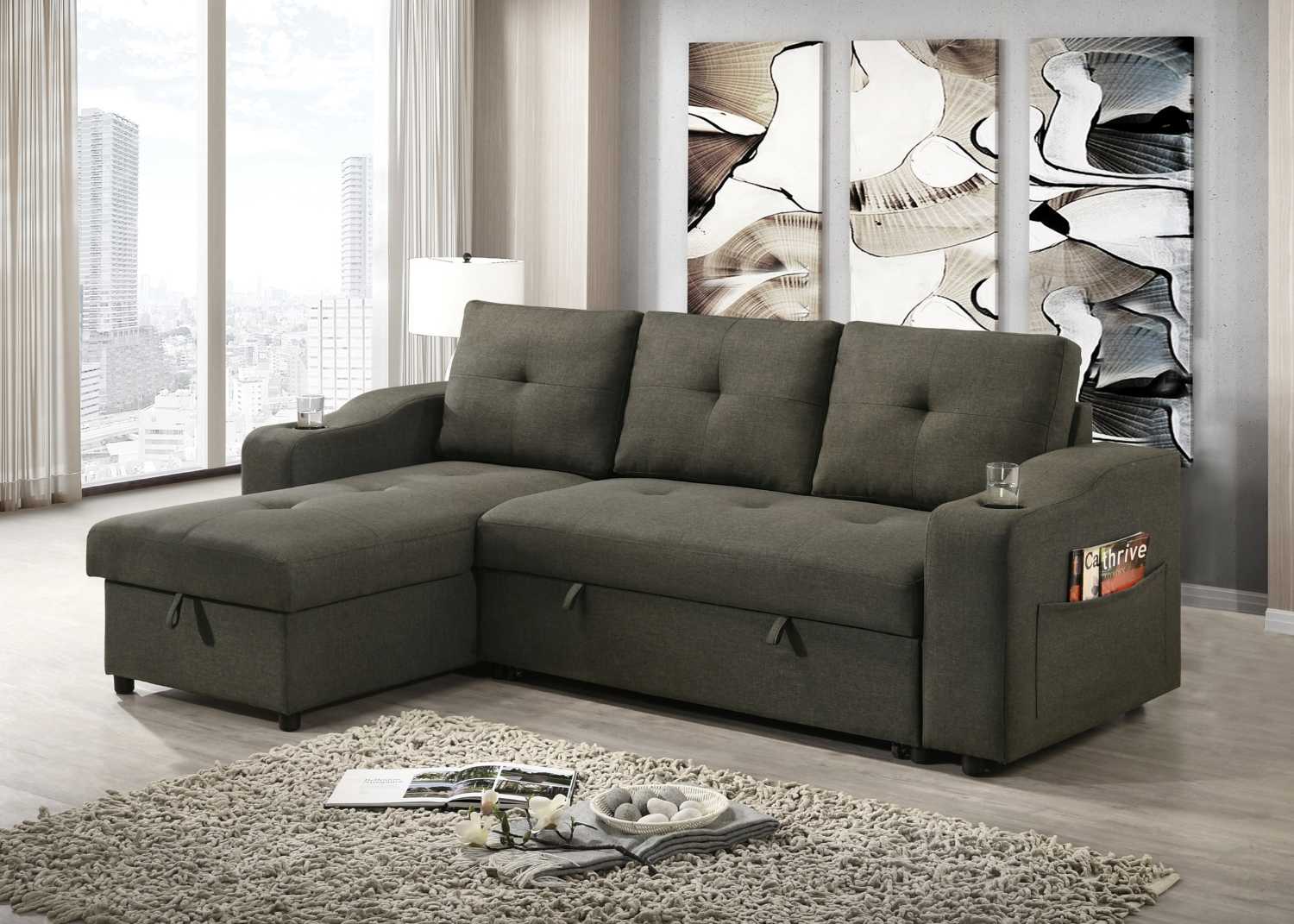 Gray sectional sofa in a living room with abstract art on the wall.
