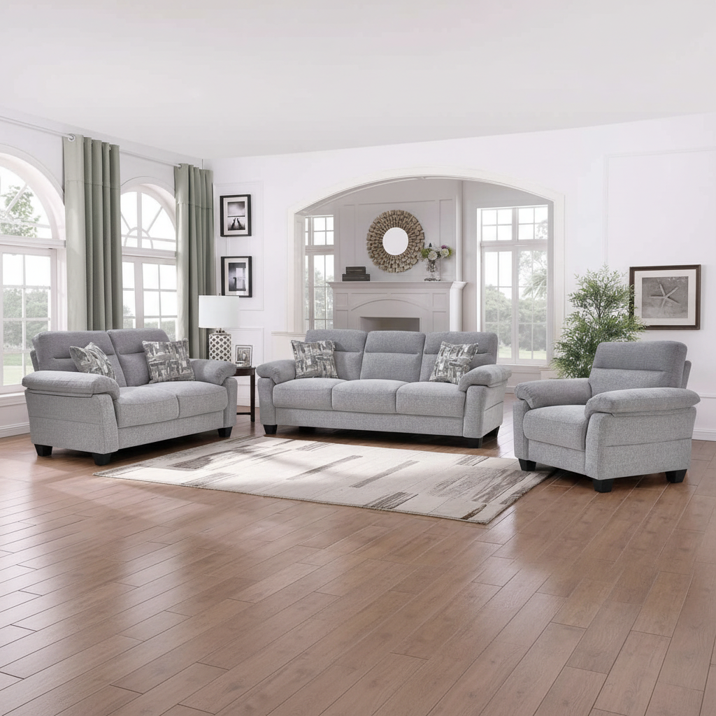 Gray sofa set in a living room with wooden floor and large windows.