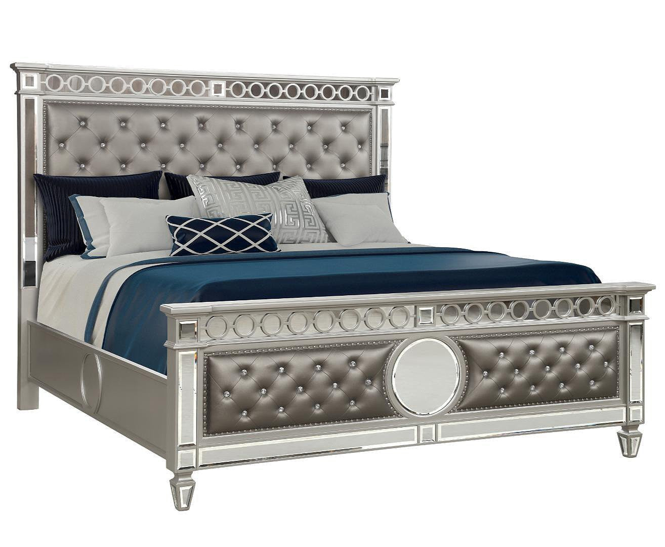 A silver-colored bed with a tufted headboard and footboard, featuring a mirror front case, with a mattress and bedding visible.