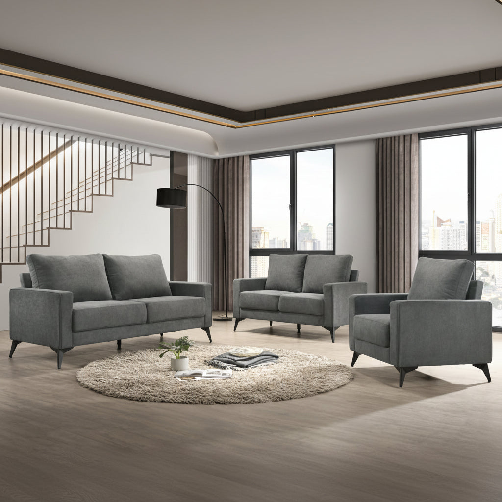 A modern gray fabric sofa set, including a sofa, loveseat, and chair, with black metal legs, arranged in a living room setting.