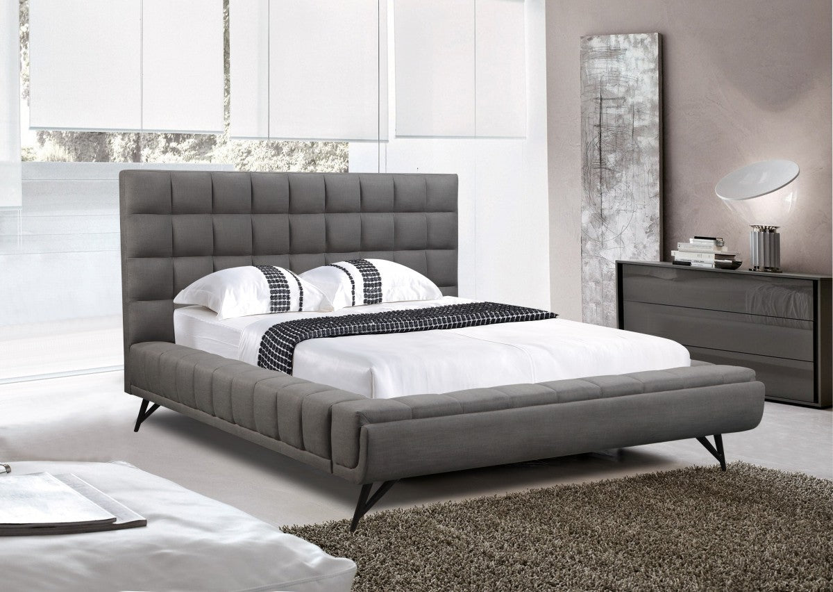 A gray platform bed with a modern design and metal legs, featured in a bedroom setting with a matching gray headboard.