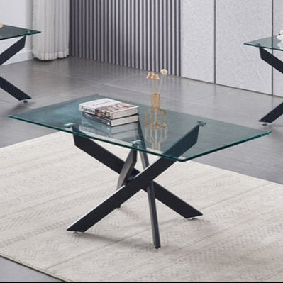 A set of clear glass coffee tables with black metal legs, including a coffee table and two end tables, displayed in a room setting.