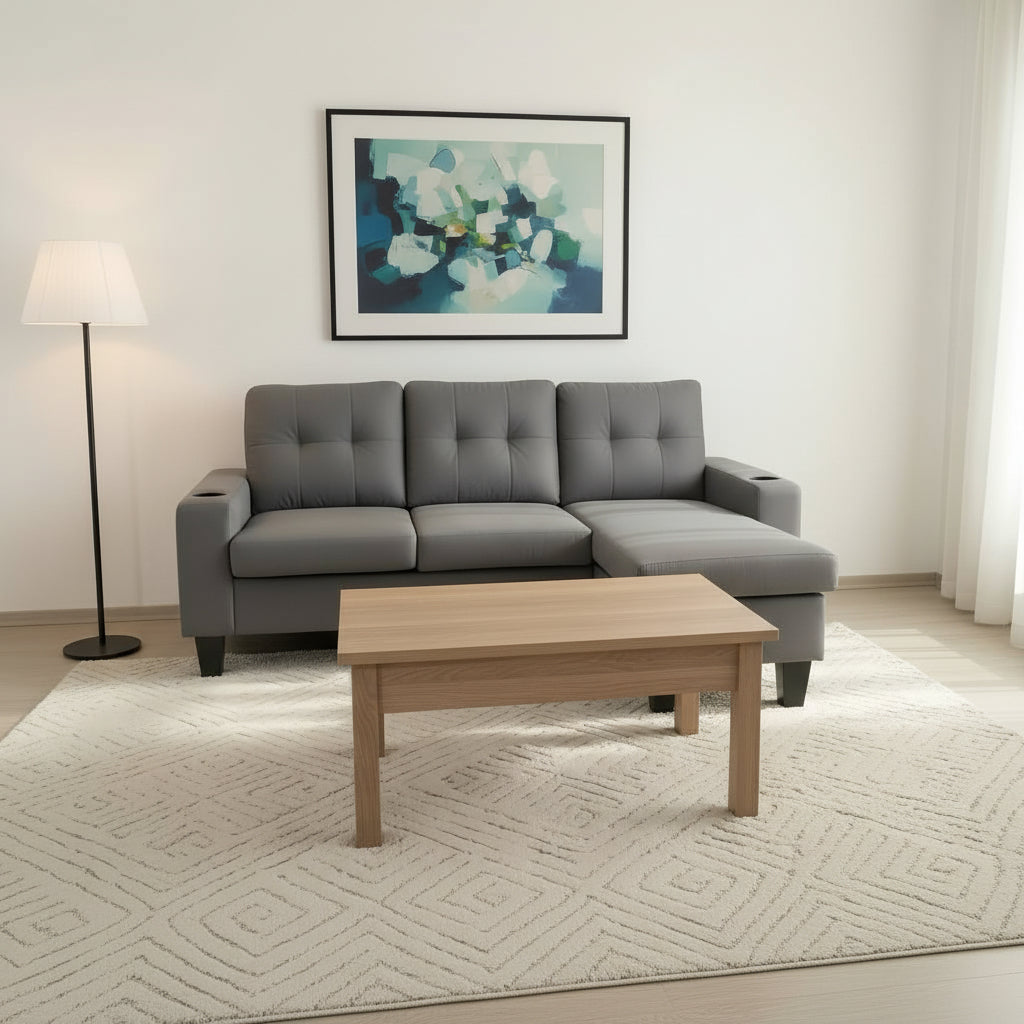 Gray sectional sofa in a living room with a wooden coffee table and abstract art on the wall.
