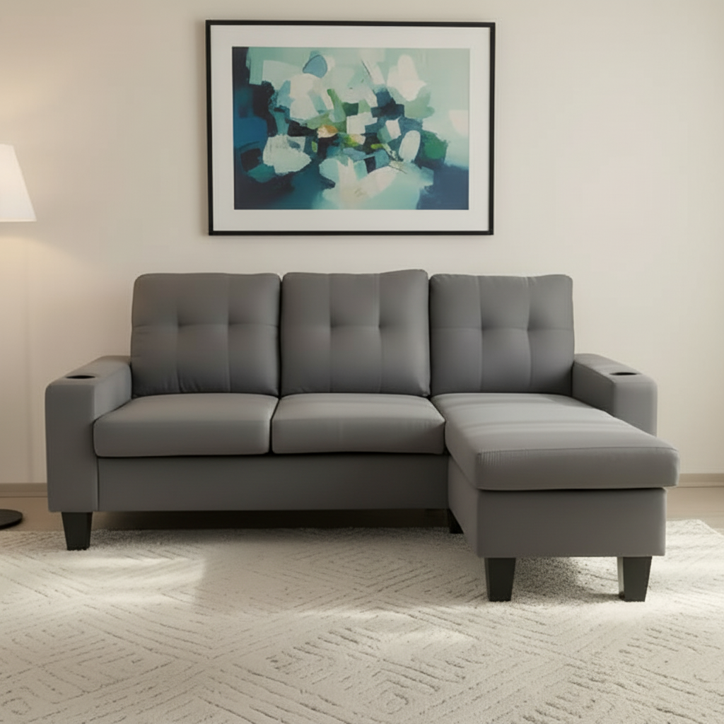 Gray sectional sofa in a living room with a wooden coffee table and abstract art on the wall.