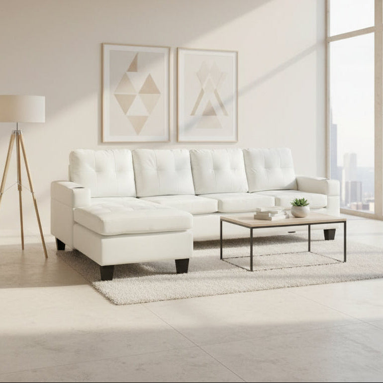 White sectional sofa in a living room with a coffee table and decor items.