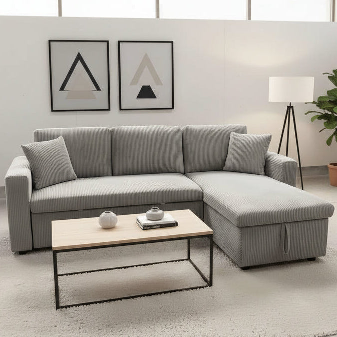 Light gray sectional sofa in a modern living room with a coffee table and decor.