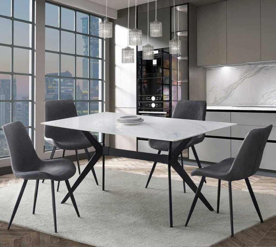 A modern dining set with a white marble appearance on the tabletop and black metal trestle base, surrounded by chairs with grey faux leather upholstery and black metal legs.