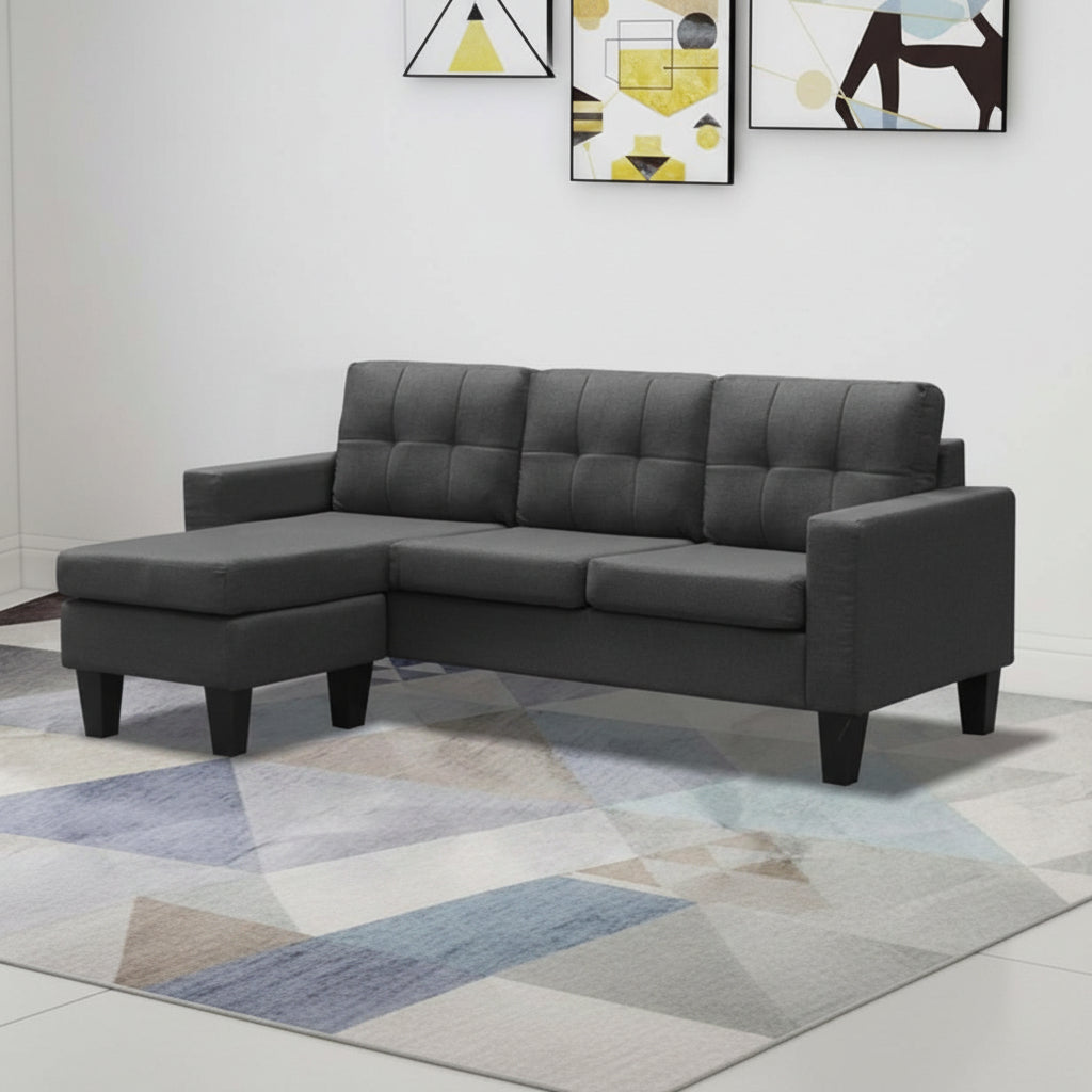 Gray sectional sofa in a room with abstract art on the wall.