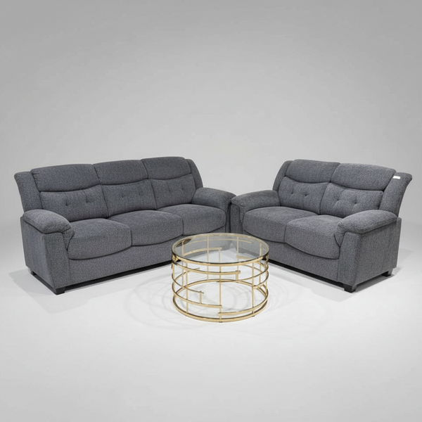 Gray sectional sofa with a gold coffee table on a gray background