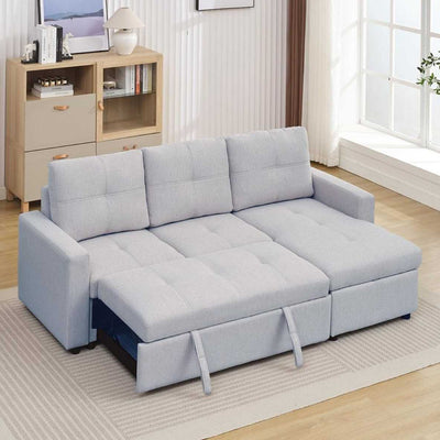 Light gray sectional sofa in a living room setting with a coffee table and bookshelf.
