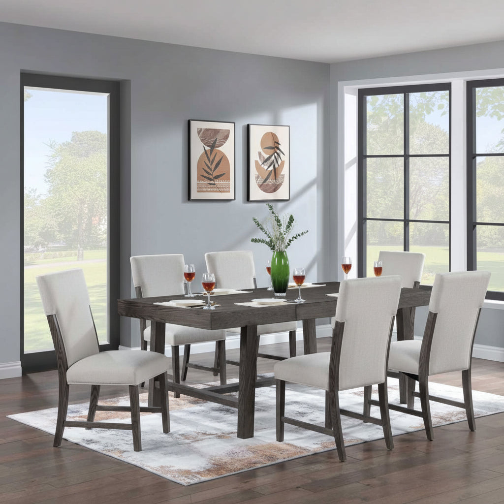 Dining room with a table and chairs in front of large windows.