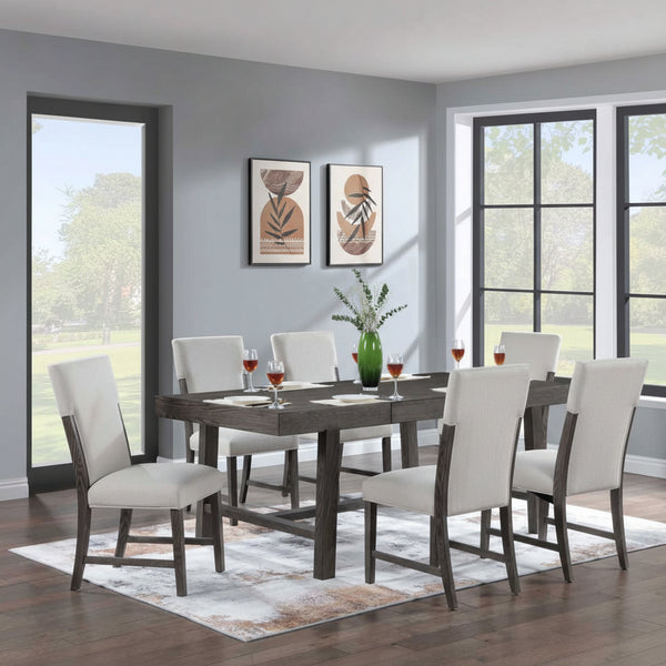 Dining room with a table and chairs in front of large windows.