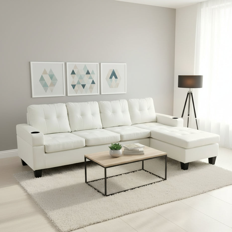 White sectional sofa in a living room with a coffee table and decor items.